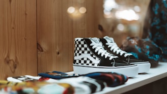 Pair of trendy sneakers displayed on a sleek shelf with urban street art background