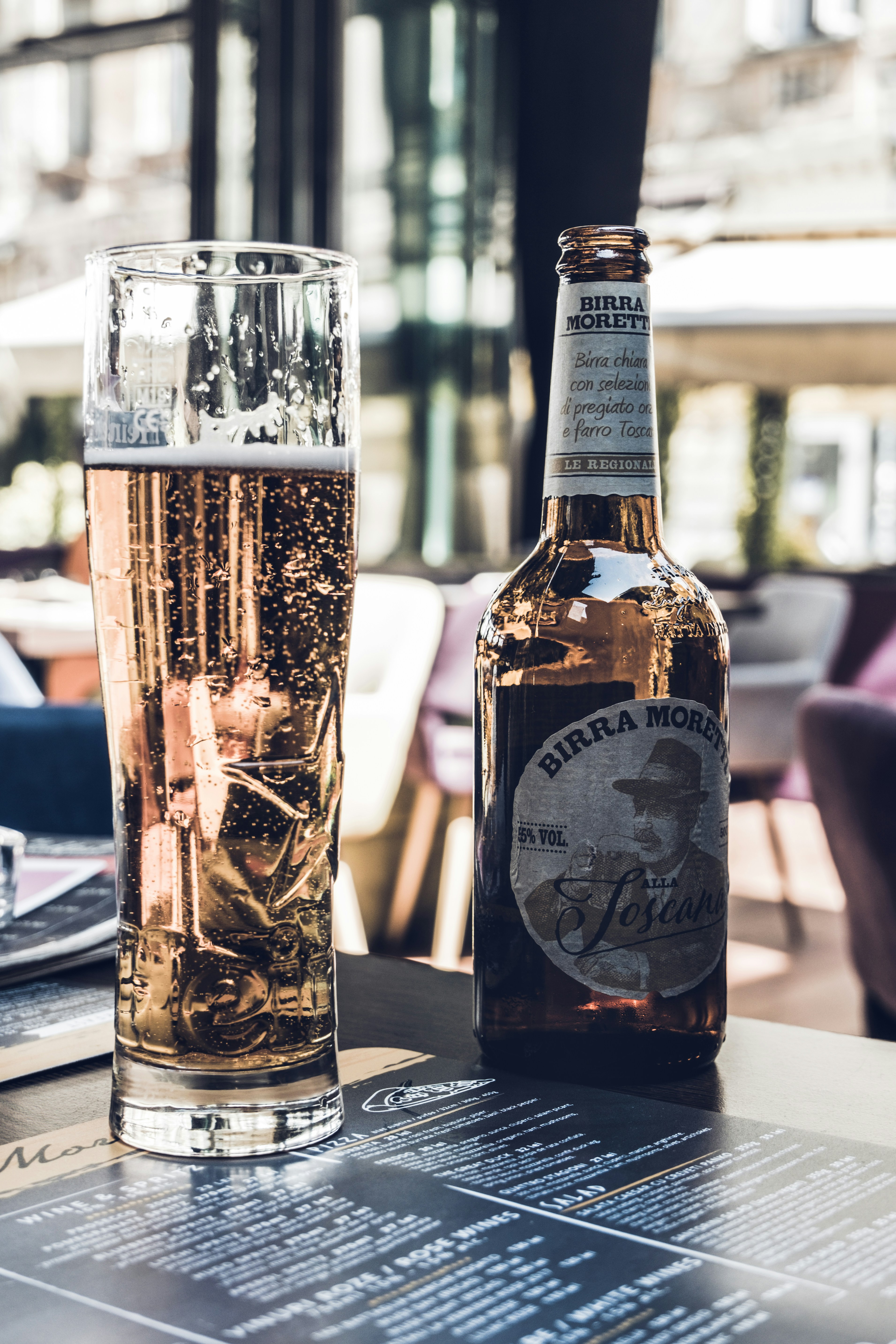 clear highball glass and brown beer bottle