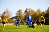Participants engaged in a friendly match under a clear sky.