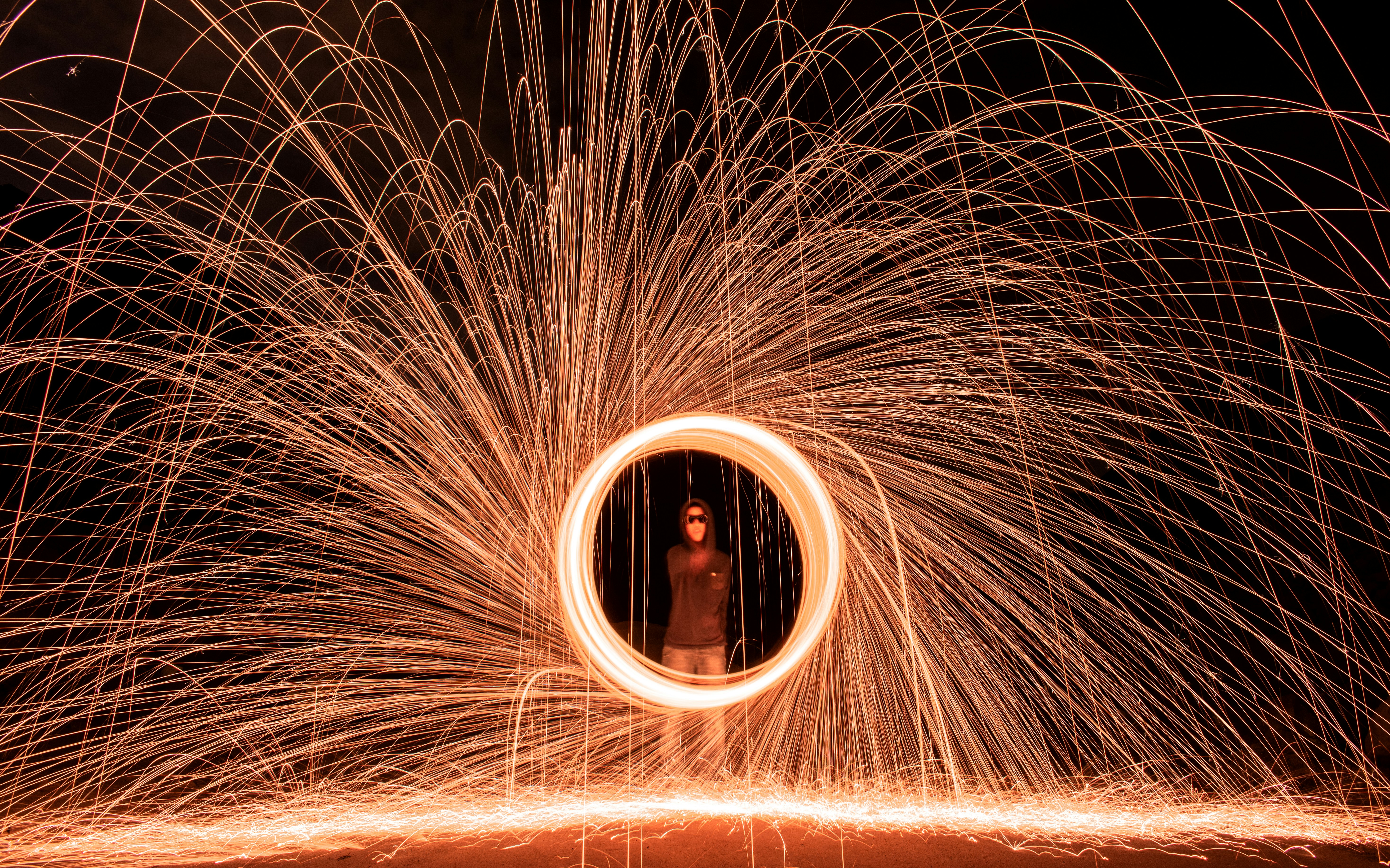 man standing in steel wool photography