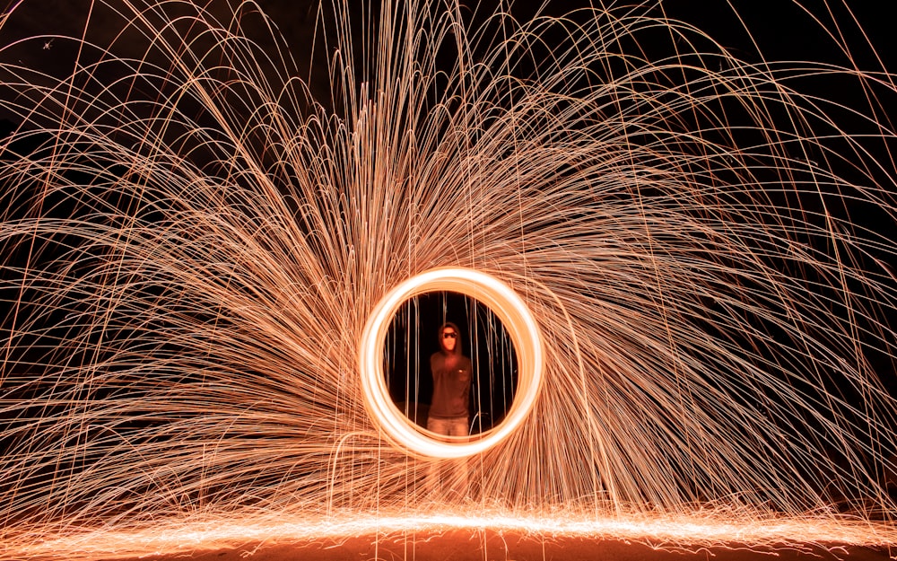man standing in steel wool photography