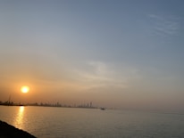 A serene sunset over Miami's skyline reflecting on the water.