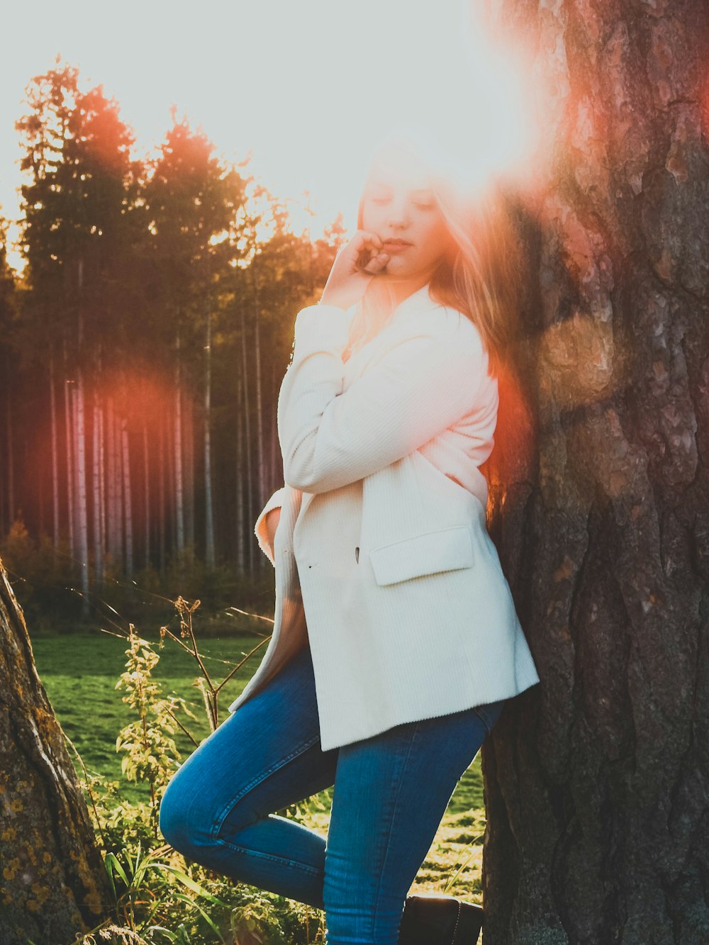 woman leaning on tree