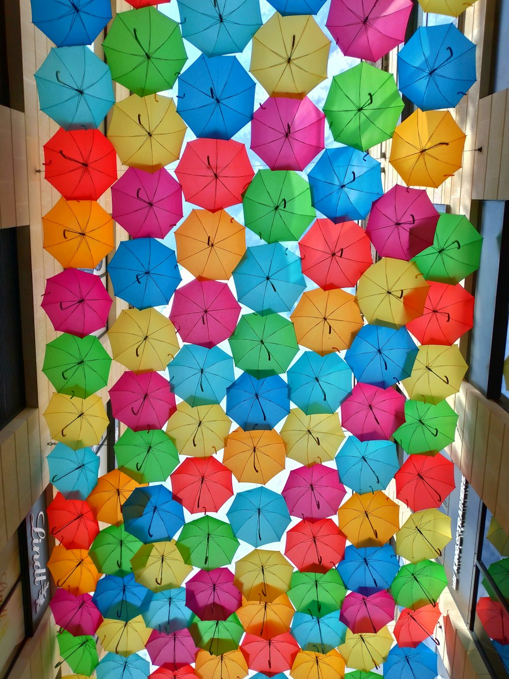 assorted-color umbrella near building