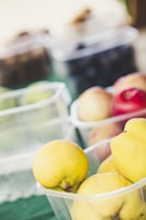 Bright colorful fruit pulps in clear containers on a wooden table