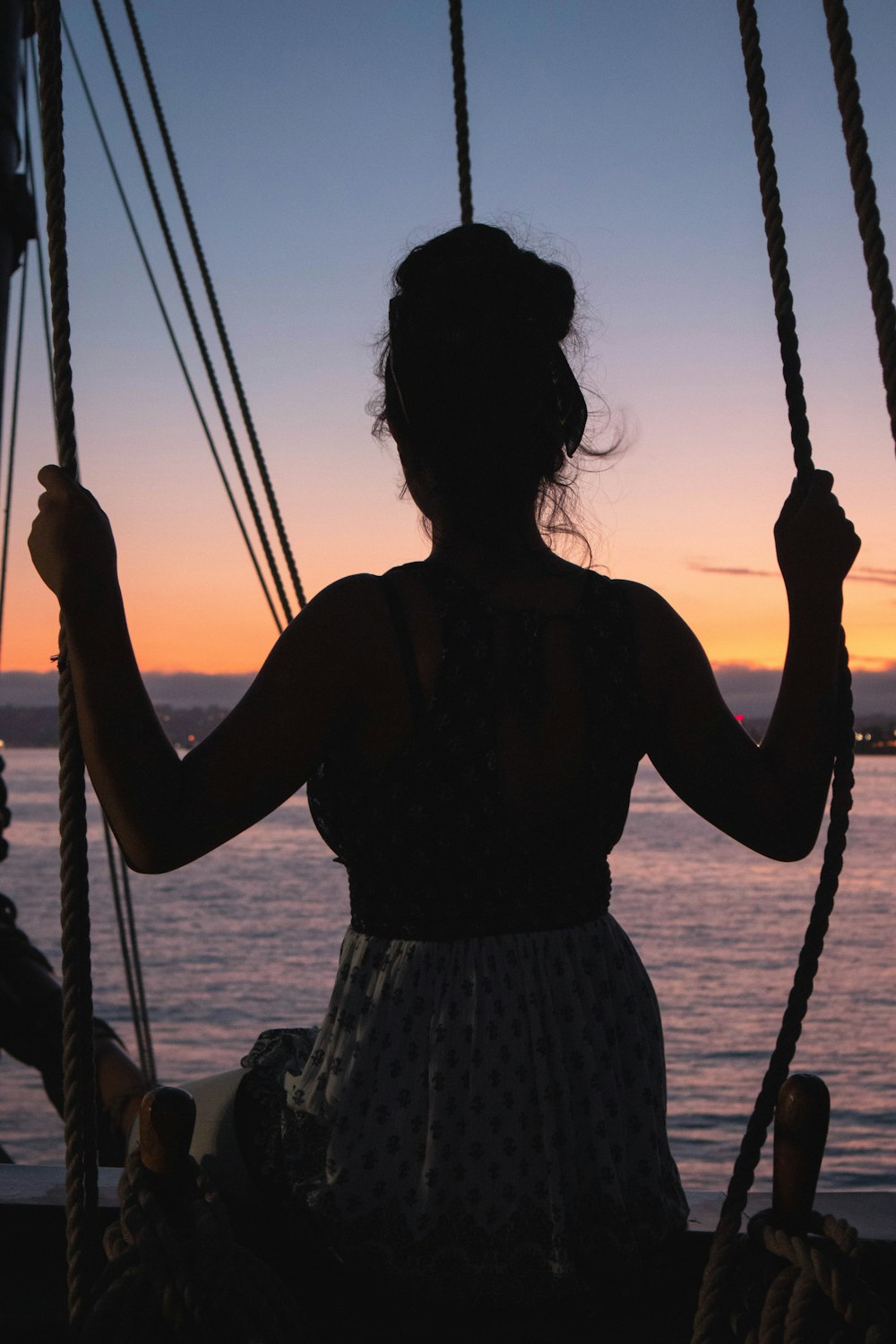 silhouette photography of woman swinging