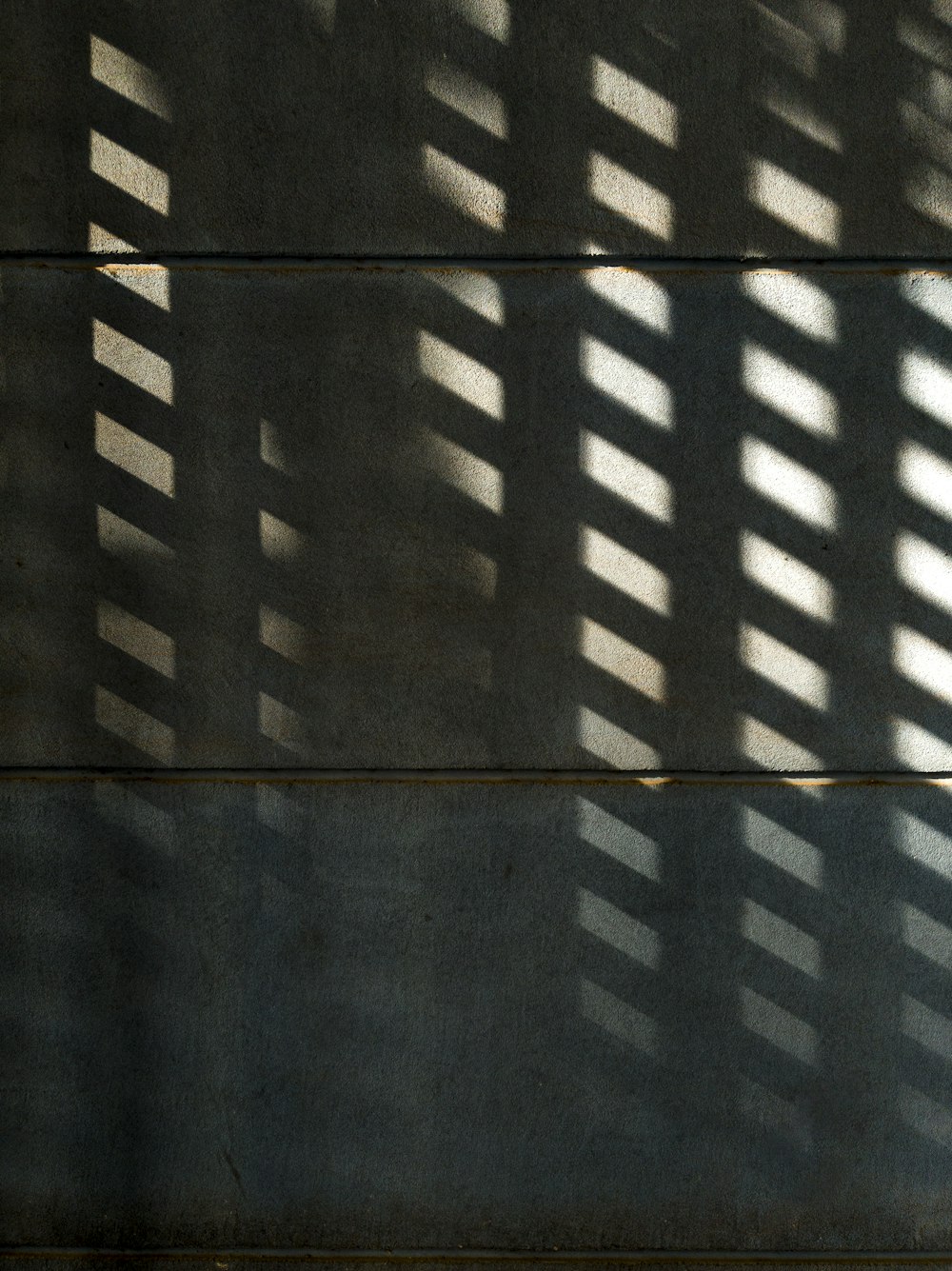 the shadow of a building on a wall