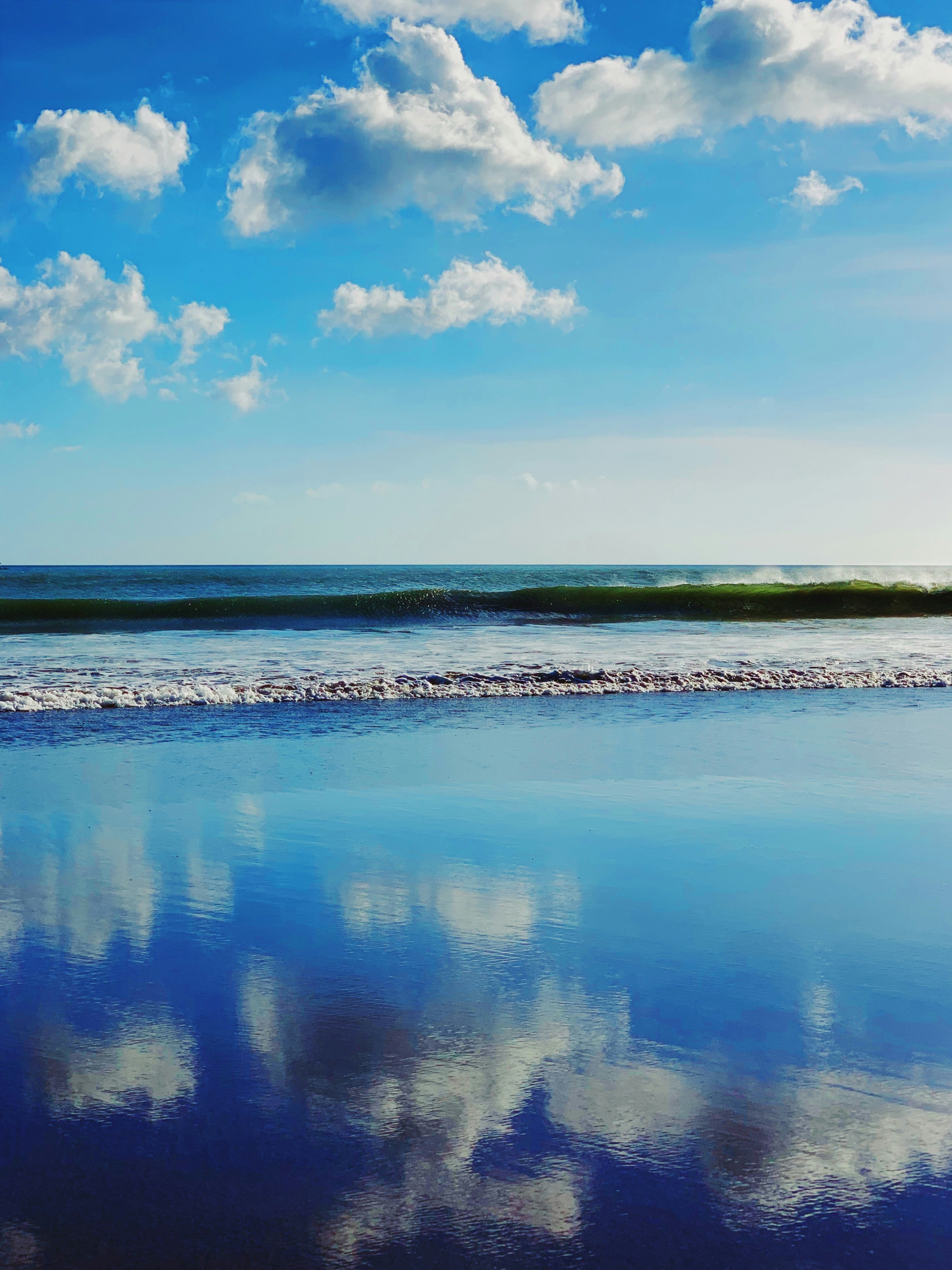 body of water and white clouds