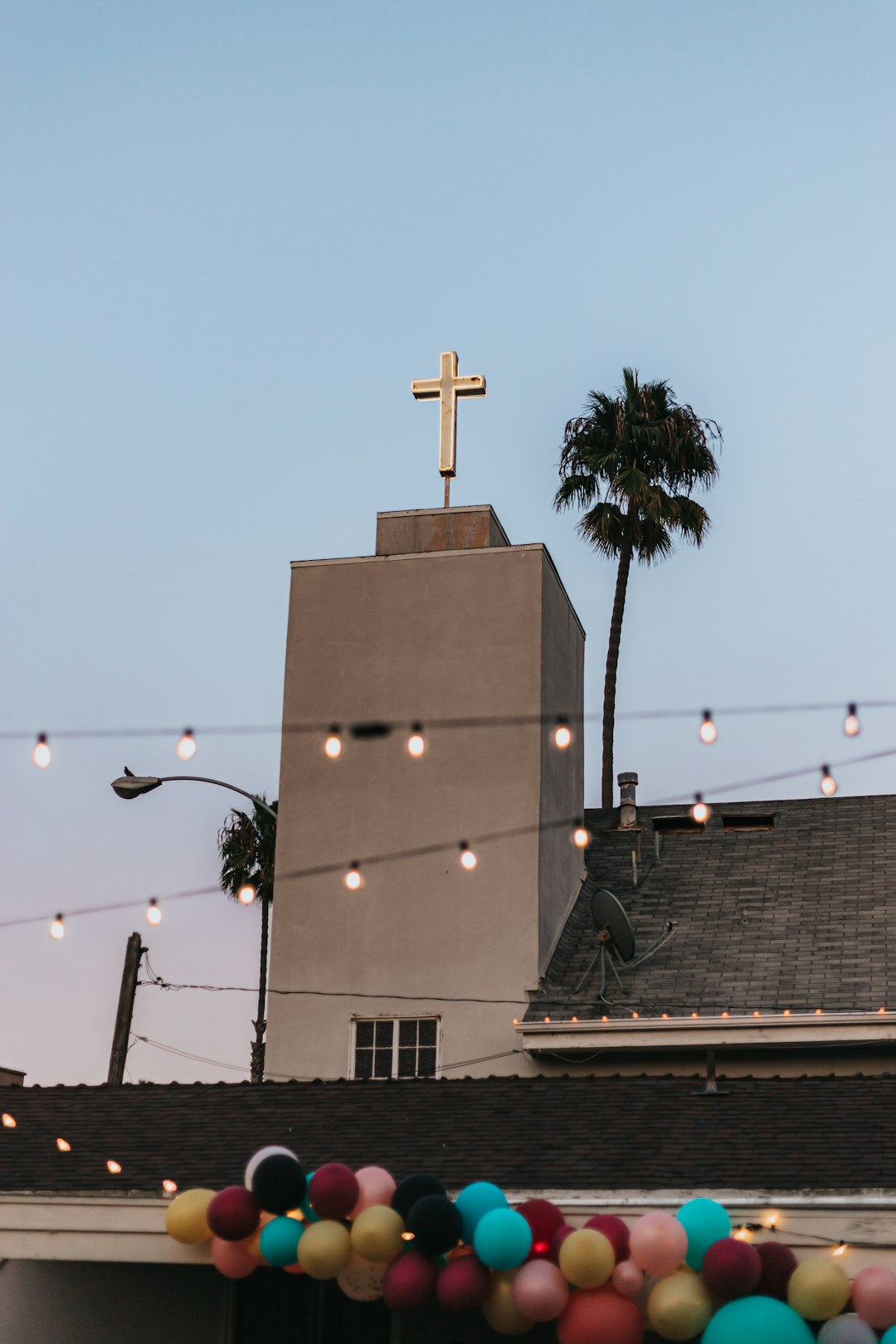 white and black church building under a calm blue sky