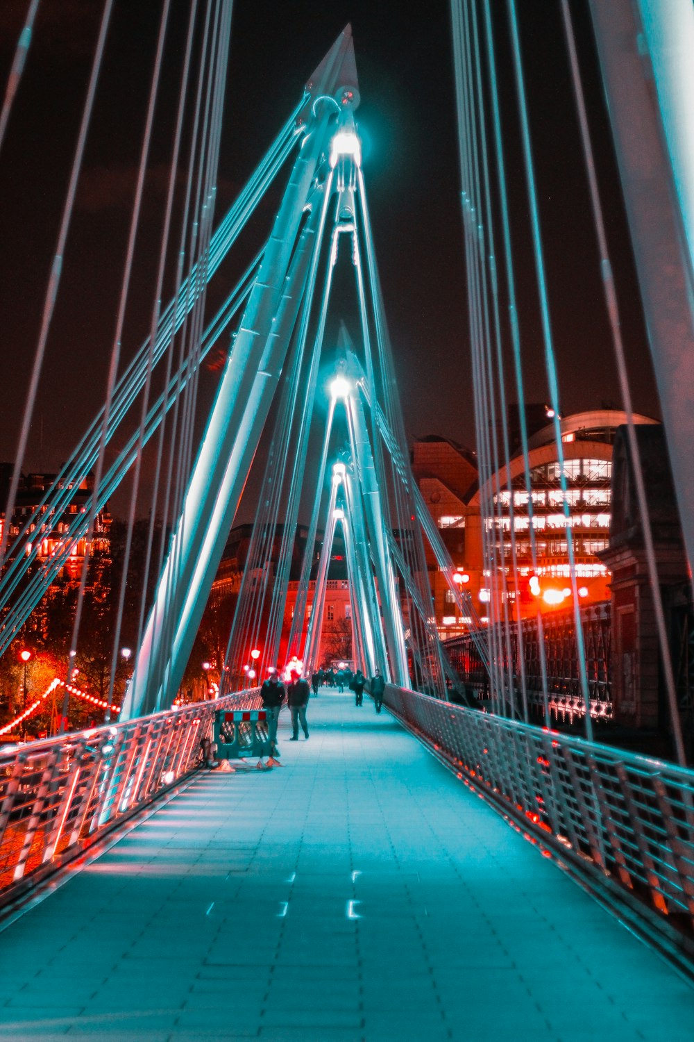 people on bridge during nighttime