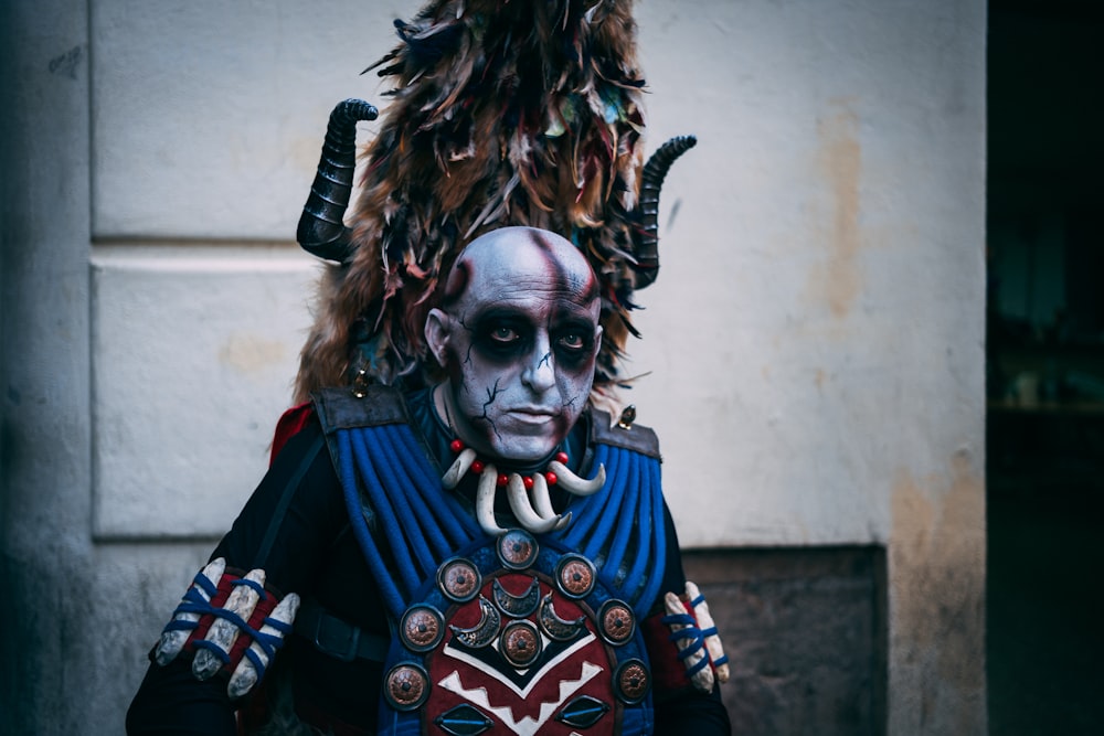 man wearing tribal costume and face paint