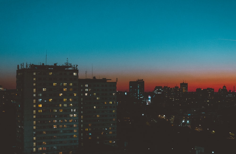 aerial photography of city with high-rise buildings during night time