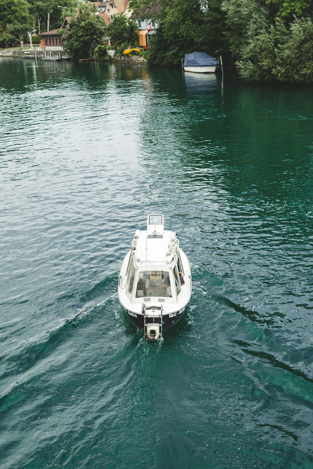 white boat vessel floating in body of water