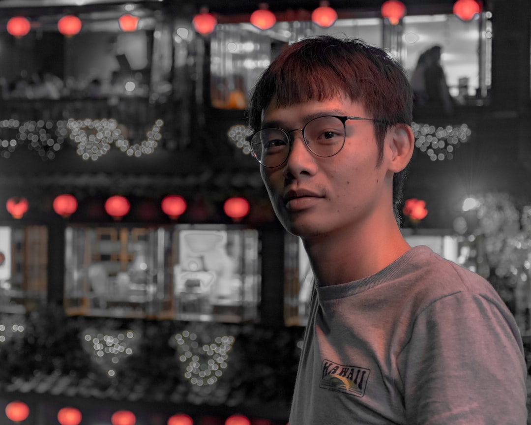 man wearing black-framed eyeglasses and gray crew-neck shirt