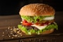 meat and cheese burger surrounded by sesame seeds