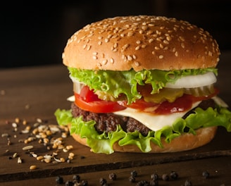 meat and cheese burger surrounded by sesame seeds