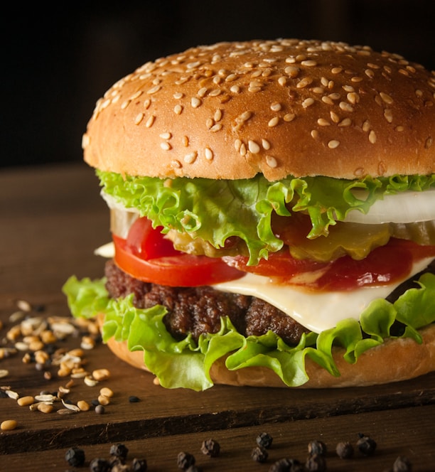 meat and cheese burger surrounded by sesame seeds