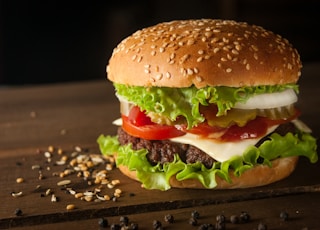 meat and cheese burger surrounded by sesame seeds