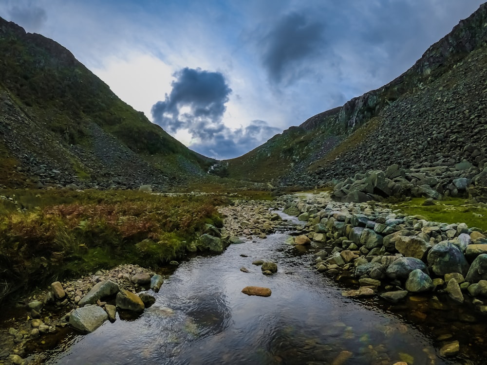 rippling river in a valley during daytime