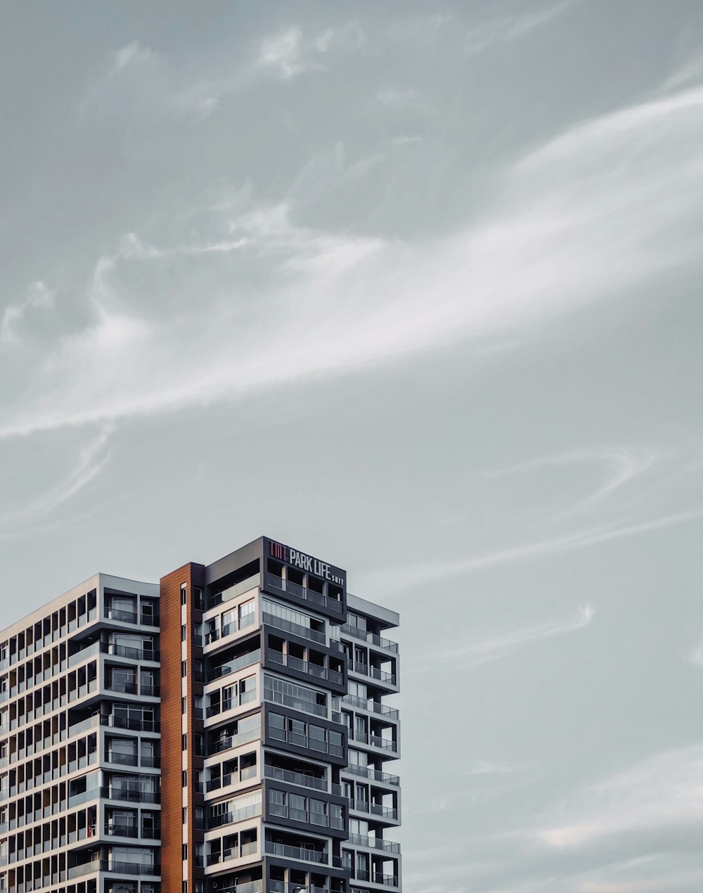 a tall building with balconies on top of it