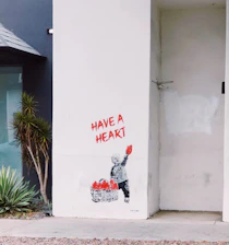 A hopeful child holding a handmade heart symbolizing courage and community support.