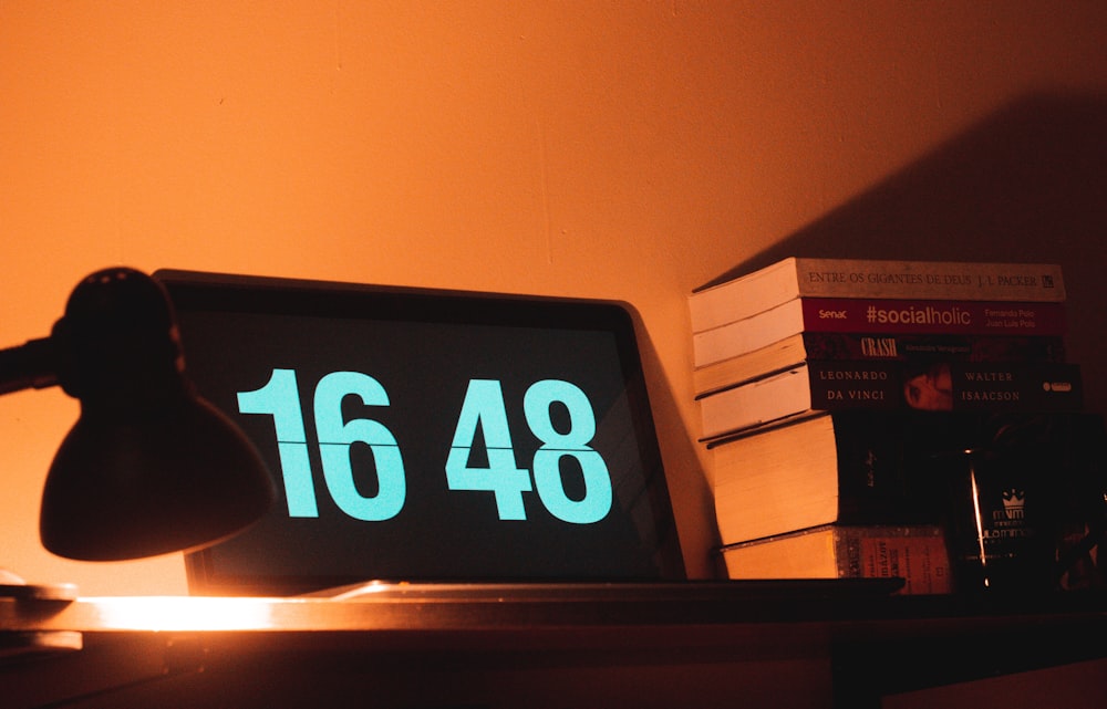 black digital clock reading at 16 48