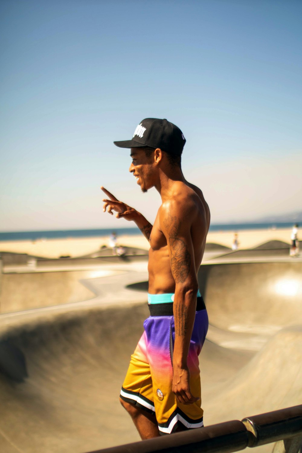 topless man on skateboard field