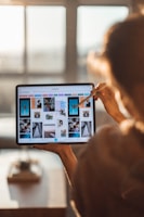 A close-up of hands editing a photo on a tablet, showcasing creativity and precision.
