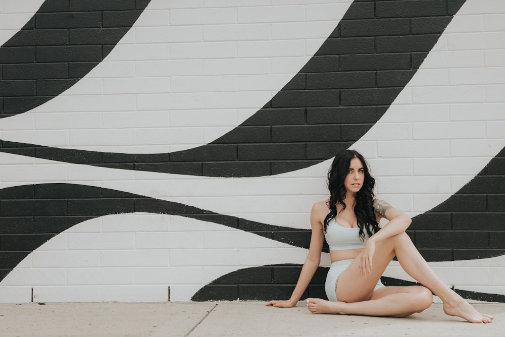 woman sitting and leaning on wall