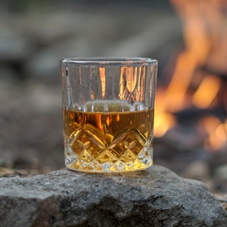 clear drinking glass with orange liquid