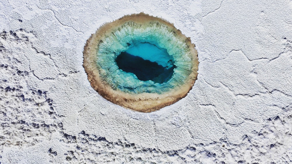 an aerial view of a blue hole in the sand