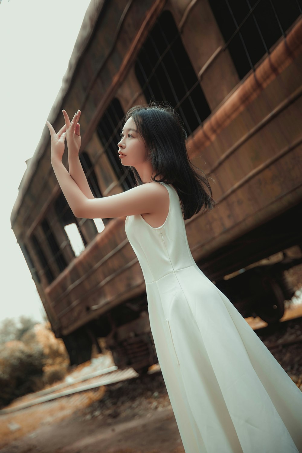 shallow focus photo of woman in white sleeveless dress