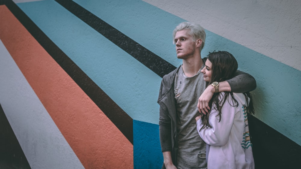 man holding shoulder of woman