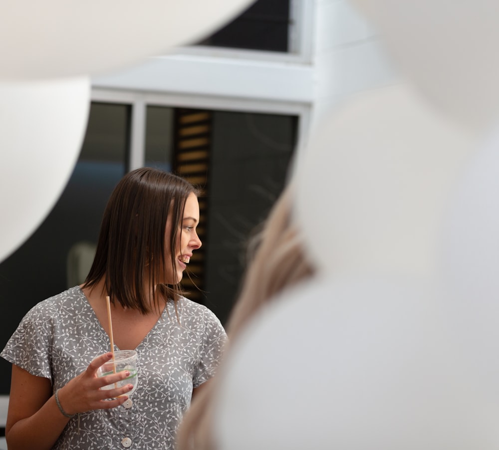 woman holding disposable cup