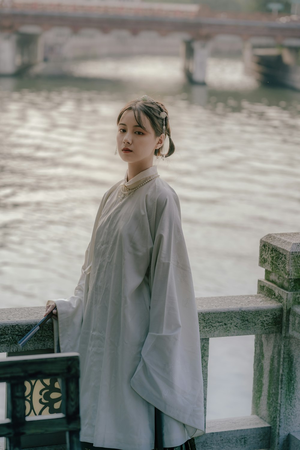 woman in gray near body of water