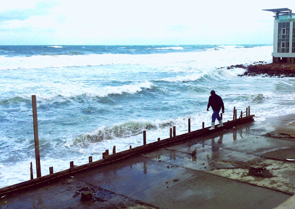 man standing near seashore