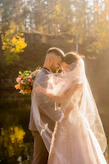 A candid wedding shot featuring natural light and warm golden tones.