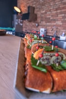 Close-up of a chef's hands garnishing a vibrant Arabic mezze platter.