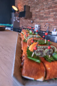 A clean and modern kitchen scene showing fresh kabab sandwiches being prepared with vibrant ingredients.