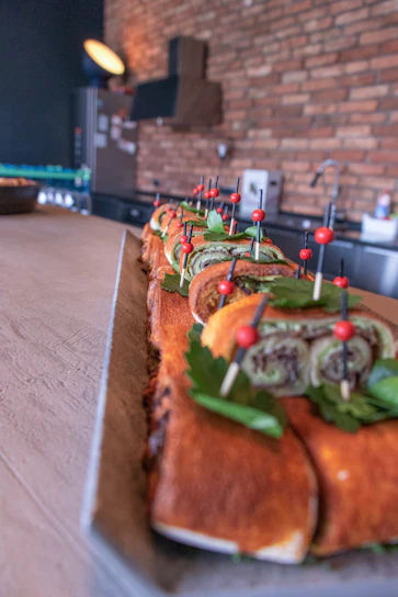 A clean and modern kitchen scene showing fresh kabab sandwiches being prepared with vibrant ingredients.
