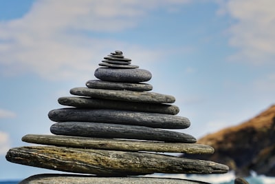 pile of gray and brown stones balanced zoom background