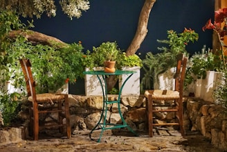 A charming rustic villa garden decorated for a wedding celebration at sunset.