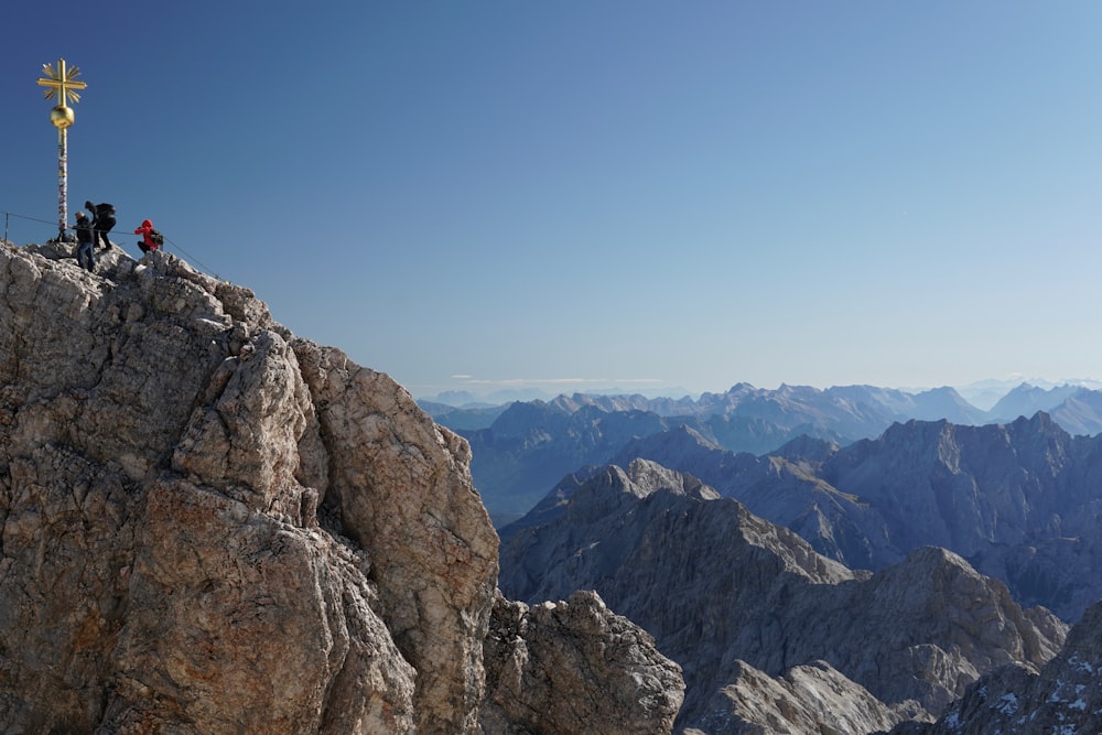 people on cliff at daytime