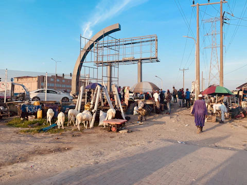 A vibrant marketplace with farmers selling cows, buffaloes, and goats.