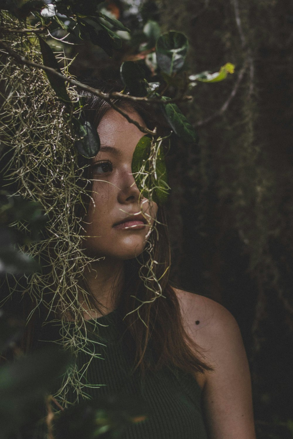 woman behind leaves