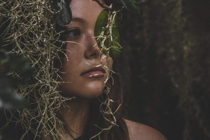 woman behind leaves