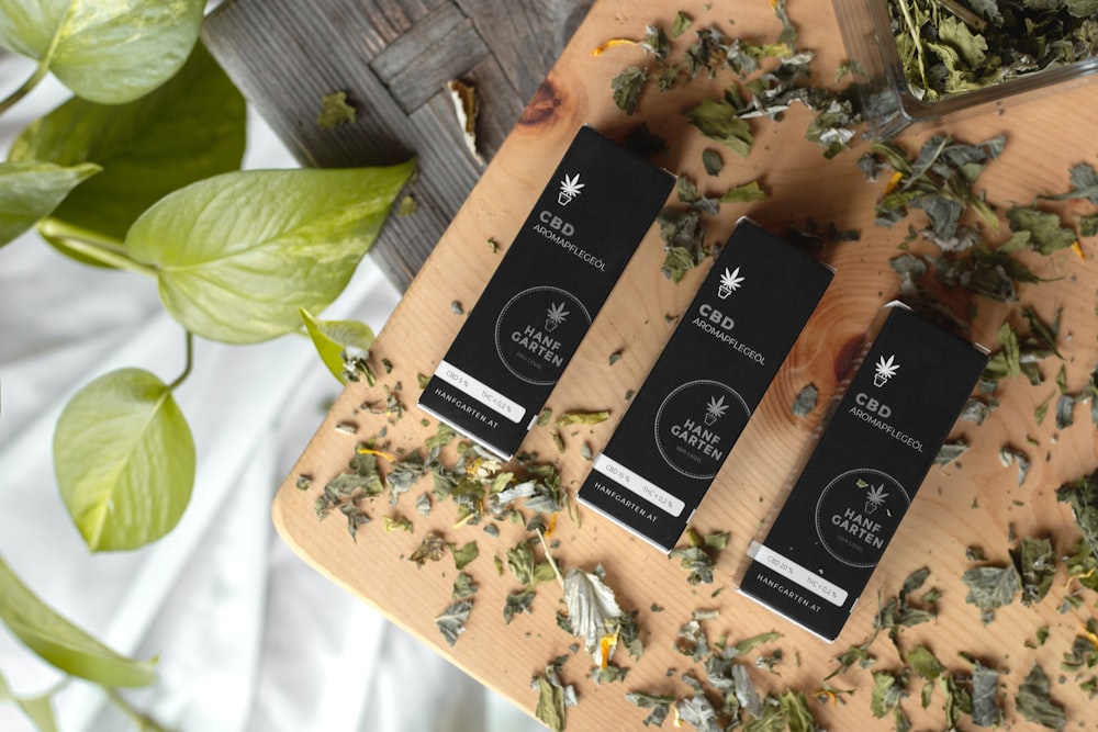 three CBD boxes near chopped herbs