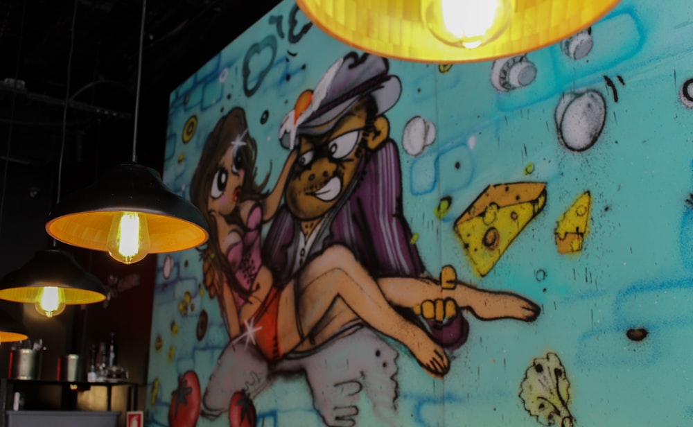 multicolored man carrying woman graffiti art near lighted pendant lamps