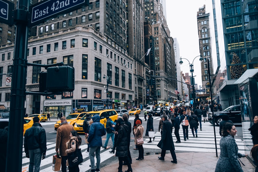 Crowd of people crossing a busy city street among office buildings abroad