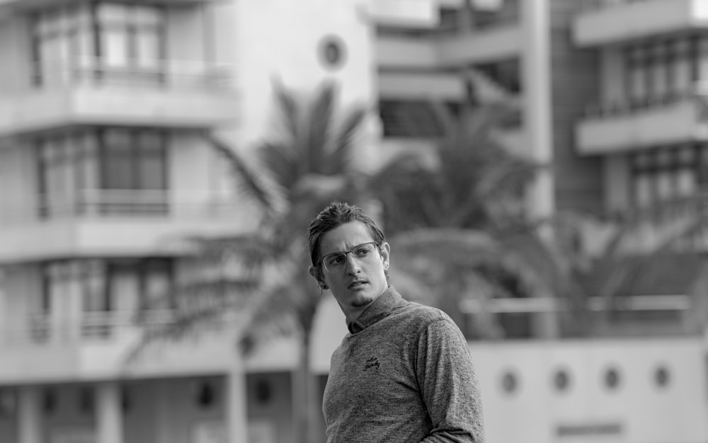 grayscale photo of man wearing long-sleeved top